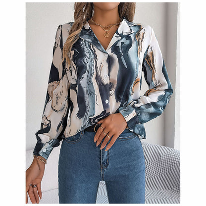 Woman wearing a long-sleeve blouse with abstract horse print and blue jeans.