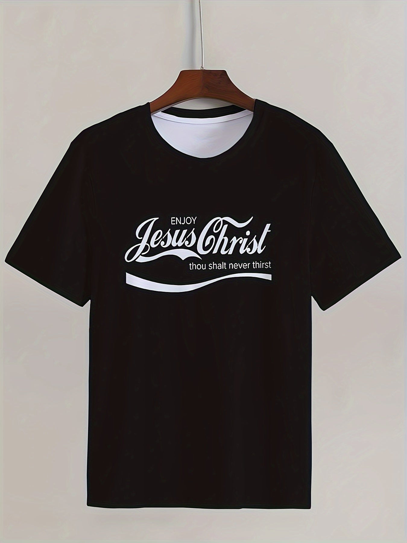 Black t-shirt with white text on a hanger against a white background