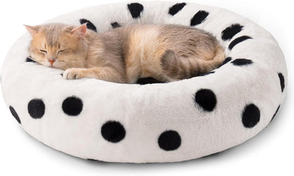 Cat sleeping in a polka dot pet bed