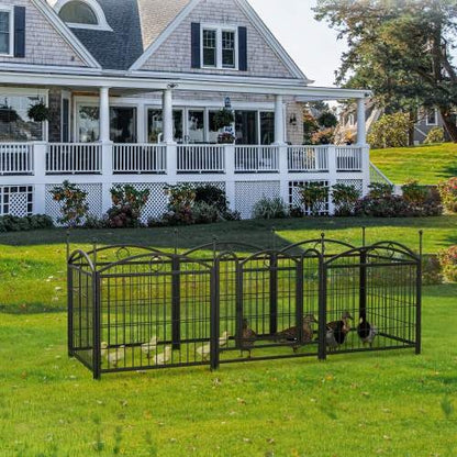 Large metal pet pen with ducks on a grassy lawn in front of a house.