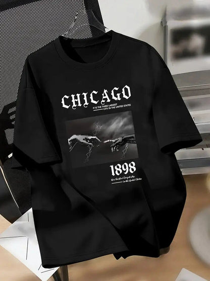Black sweatshirt with 'Chicago' graphic design on a wooden surface