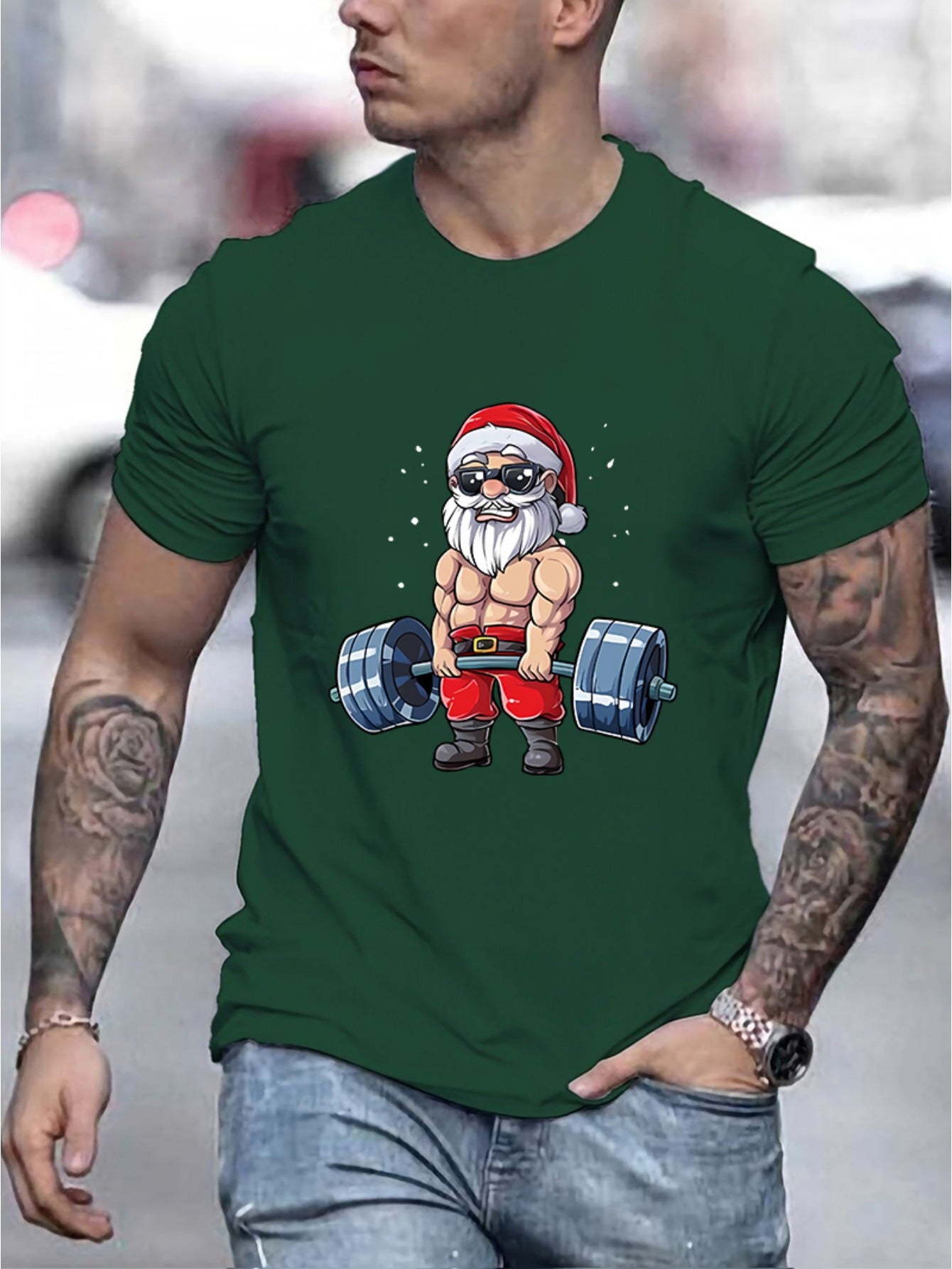 Man wearing a green t-shirt with a graphic of Santa Claus lifting weights.