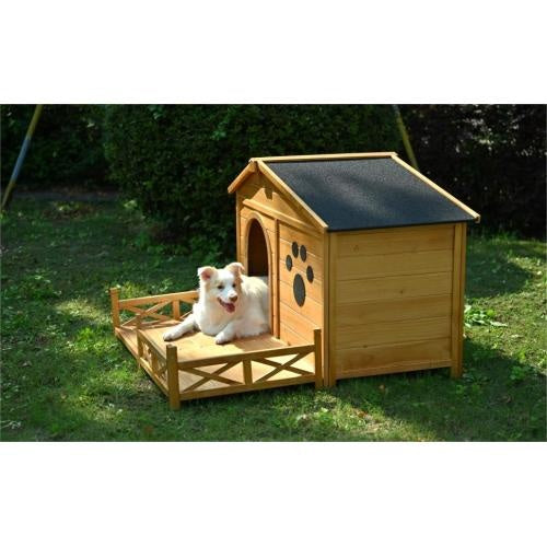 Wooden dog house with a dog inside on a grassy area