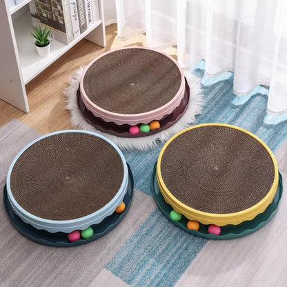 Three round cat scratchers with colorful balls on a carpeted floor.