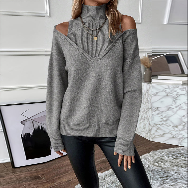 Person wearing a gray off-shoulder sweater in a room with decor elements.