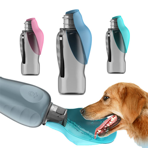 Dog drinking water from a blue pet water bottle with additional bottles in different colors on a white background.