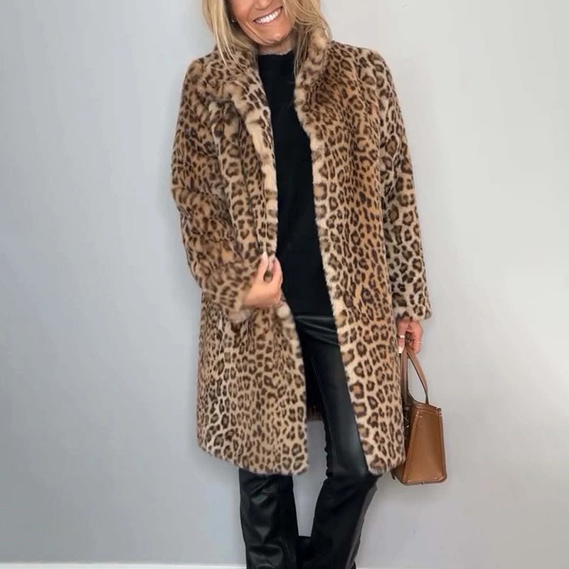 Person wearing a leopard print coat with a plain background