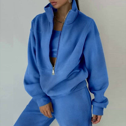 Person wearing a blue tracksuit against a plain background