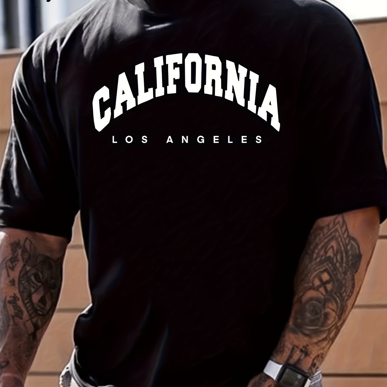 Person wearing a black t-shirt with 'California Los Angeles' text