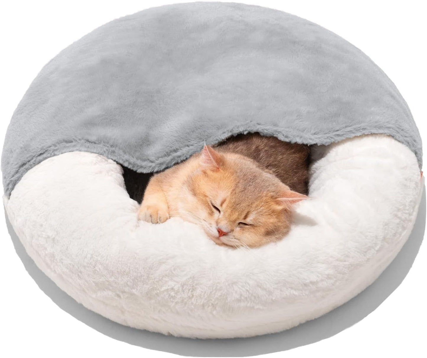 Cat sleeping in a round, plush pet bed with gray top and white bottom.