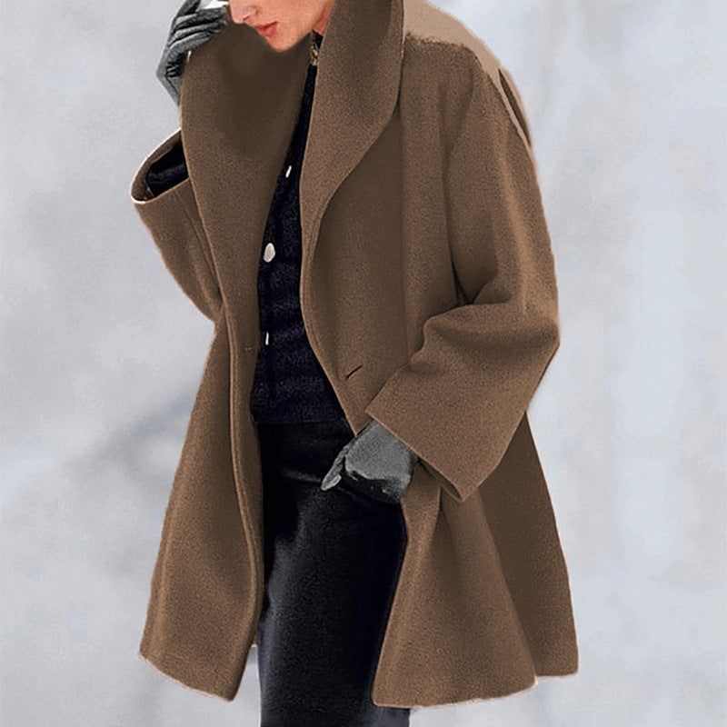 Person wearing a brown coat with a blurred background