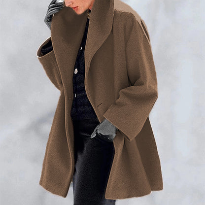 Person wearing a brown coat with a blurred background