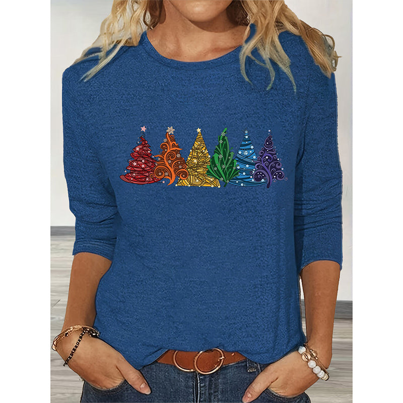 Blue sweater with colorful Christmas tree design worn by a person.