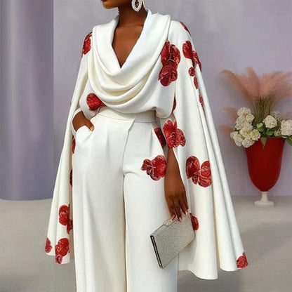 White outfit with red floral patterns worn by a model against a neutral background